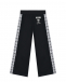 Черные спортивные брюки с лампасами Moschino | Фото 1