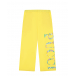 Желтые спортивные брюки с разноцветным лого  | Фото 1